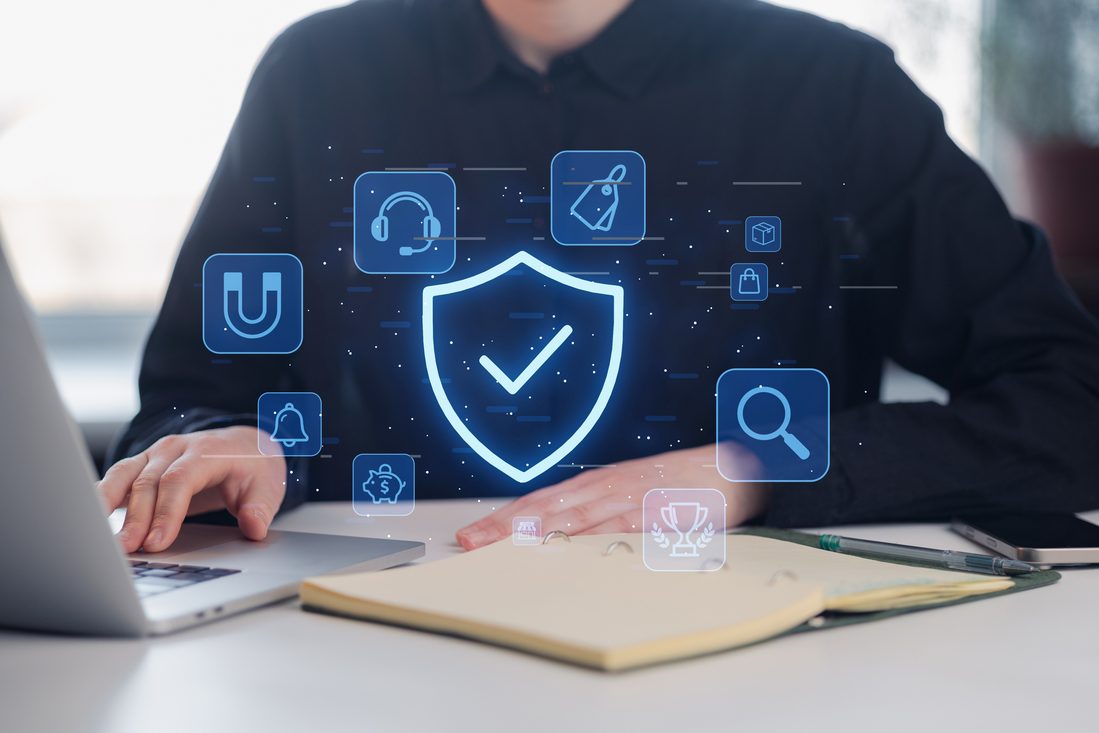 Security shield and compliance icons layered over a laptop screen